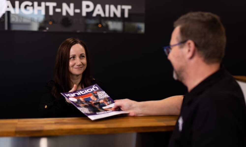 image of Straight-N-Paint receptionist talking with collision repair customer at front desk in Rangiora, North Canterbury