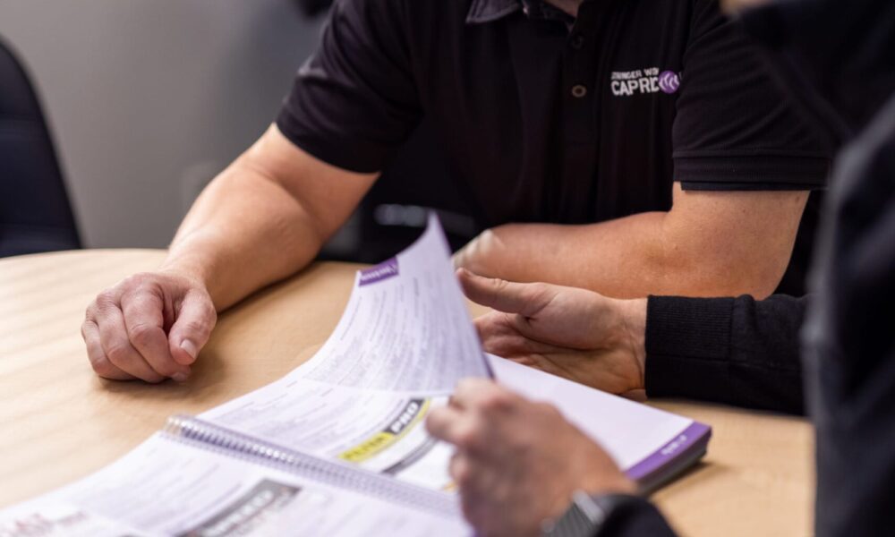 image of Straight-N-Paint employee talking to collision repair customer at Rangiora office in Canterbury