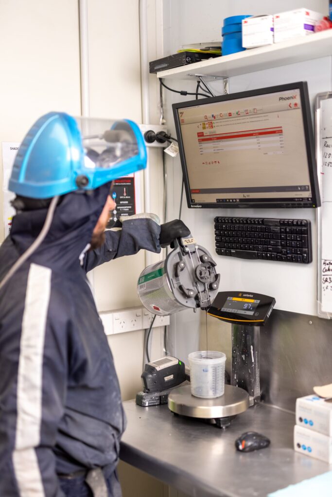 image of Straight-N-Paint employee preparing spray painting equipment in Rangiora collision repair workshop