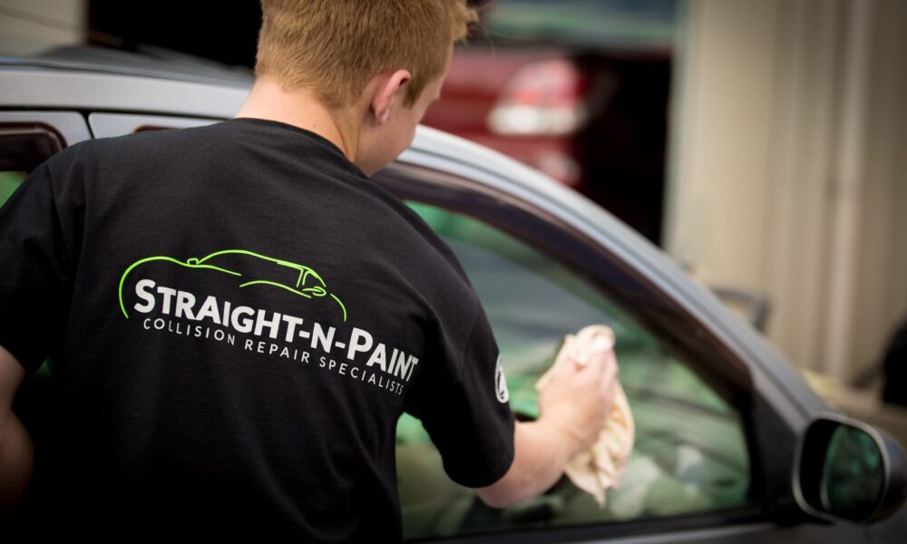 image of Straight-N-Paint employee cleaning car window as part of their car grooming service in Christchurch and Rangiora